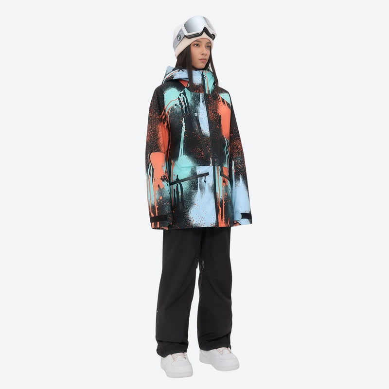 Insulated bib snow pants for women - orange and blue abstract print jacket with black pants, for resort and backcountry days