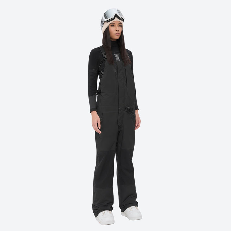 Women's adjustable ski pants with suspenders - black bib pants, on-model front view, for skiing and snowboarding