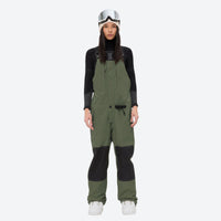 
                  
                    Women's adjustable ski pants with suspenders - olive green bib pants, on-model front view, for cold-weather winter sports
                  
                