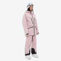 
                  
                    Insulated bib snow pants for women - pink, on-model three-quarter front view, for resort and backcountry days
                  
                