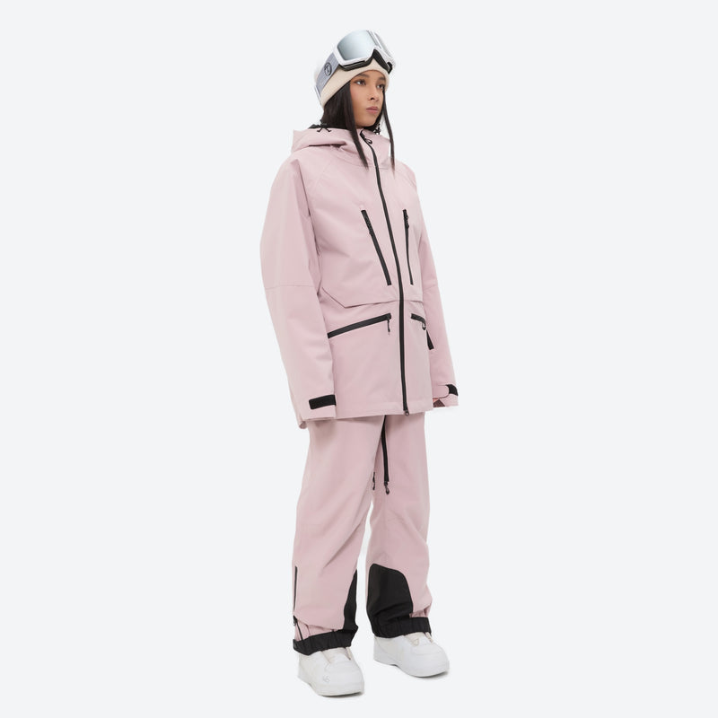 Insulated bib snow pants for women - pink, on-model three-quarter front view, for resort and backcountry days