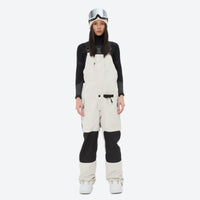 
                  
                    Women's adjustable ski pants with suspenders - white bib pants, on-model front view, for deep powder winter days
                  
                