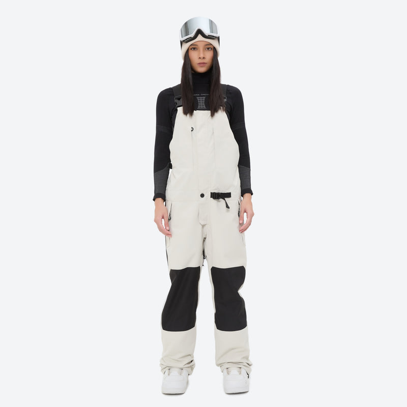 Women's adjustable ski pants with suspenders - white bib pants, on-model front view, for deep powder winter days