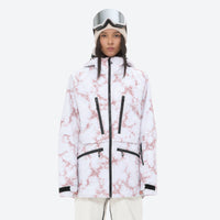 
                  
                    Women's adjustable ski pants with suspenders - white marble print, on-model front view, for deep powder winter days
                  
                