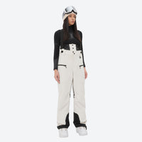 
                  
                    Insulated bib snow pants for women - cream bib pants, on-model front view, for resort and backcountry days
                  
                