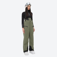 
                  
                    Insulated bib snow pants for women - olive green bib pants, on-model front view, for cold-weather winter sports
                  
                
