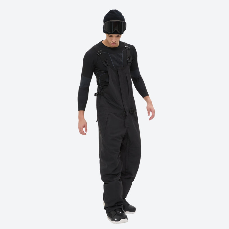 Men's adjustable ski pants with suspenders - black bib pants, on-model side view, for skiing and snowboarding