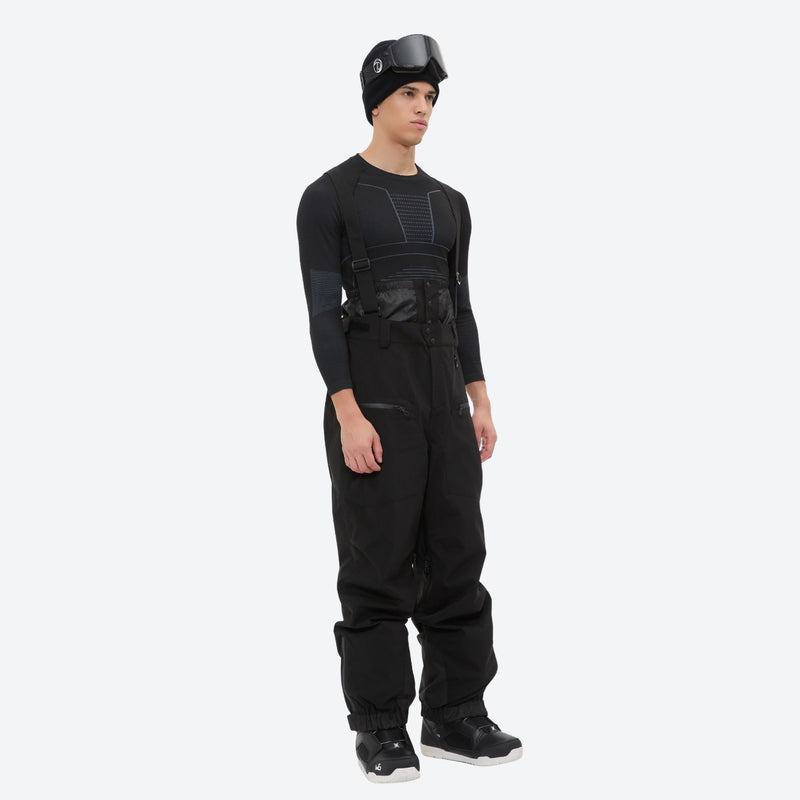 Men's adjustable ski pants with suspenders - black bib pants, on-model three-quarter front view, for skiing and snowboarding