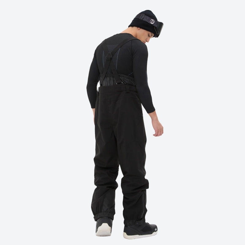 Men's adjustable ski pants with suspenders - black bib pants, on-model side view, for cold-weather winter sports