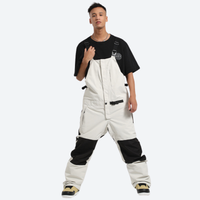 
                  
                    Unisex waterproof 3L bib snow pants - white bib snow pants with black tee, for powder and piste riding
                  
                