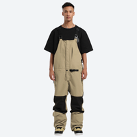 
                  
                    Unisex waterproof 3L bib snow pants - beige bib snow pants with black tee, for resort and backcountry days
                  
                