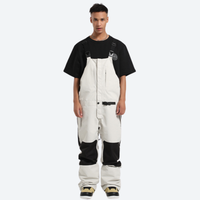 
                  
                    Unisex bib snowboard pants with snow gaiters - white bib snow pants with black tee, for resort and backcountry days
                  
                