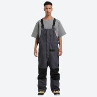 
                  
                    Breathable 3-layer suspender ski pants with pockets - gray bib snow pants with gray tee, for resort and backcountry days
                  
                
