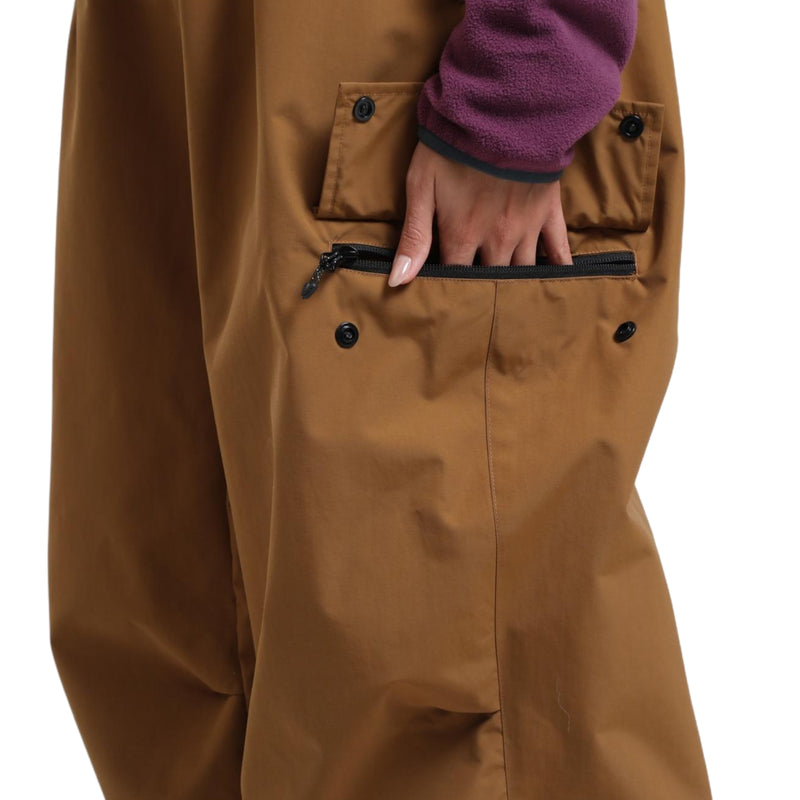 Unisex breathable wide-leg ski pants - tan snow pants, cargo pocket close-up with hand, for resort and street wear