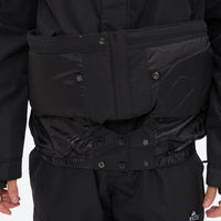 
                  
                    Unisex snowboard jacket and bibs set - black, inner snow skirt close-up detail, for cold-weather winter sports
                  
                