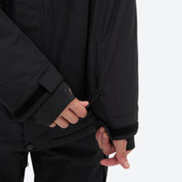 
                  
                    Breathable 2-layer ski jacket with suspender bibs - black, cuff close-up with hand, for resort and backcountry days
                  
                