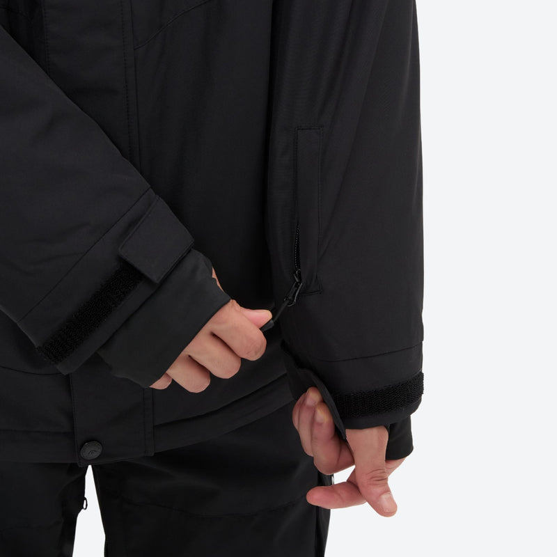 Breathable 2-layer ski jacket with suspender bibs - black, cuff close-up with hand, for resort and backcountry days