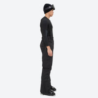 
                  
                    Breathable 2-layer ski jacket with suspender bibs - black bib pants, on-model side view, for skiing and snowboarding
                  
                
