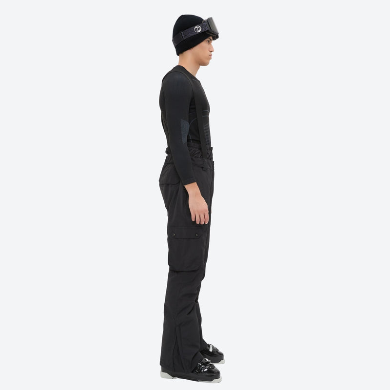 Breathable 2-layer ski jacket with suspender bibs - black bib pants, on-model side view, for skiing and snowboarding