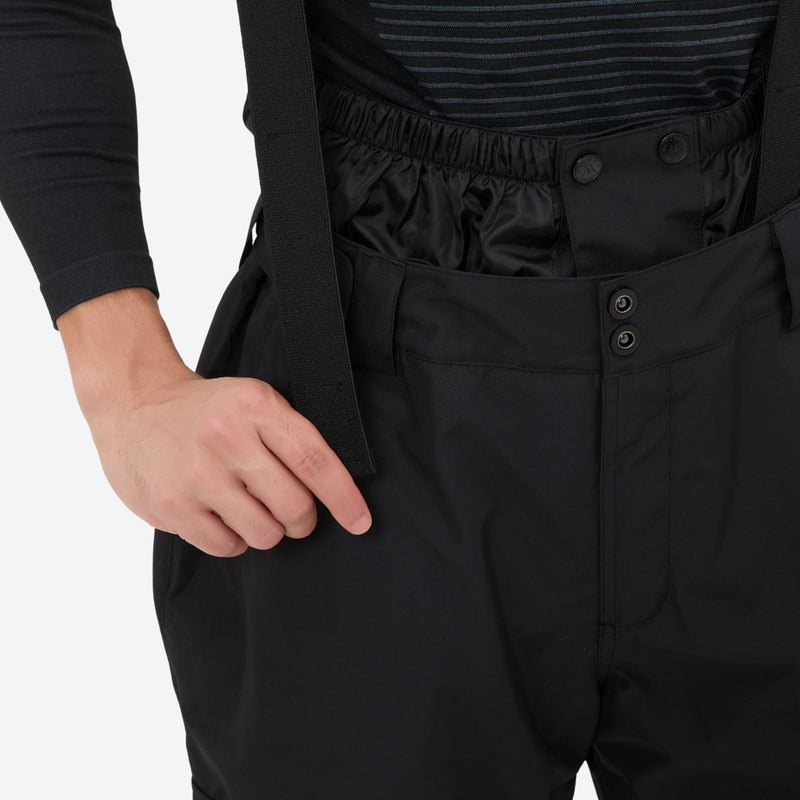 Unisex snowboard jacket and bibs set - black bib pants, bib waist strap close-up with hand, for cold-weather winter sports