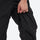 Unisex snowboard jacket and bibs set - black bib pants, knee zip vent close-up with hand, for powder and piste riding