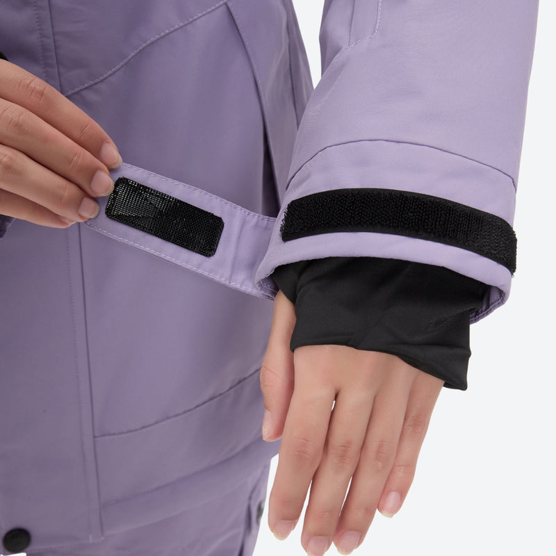 Women's waterproof 2L ski jacket and bib pants - lavender, cuff close-up with hand, for resort and cross-country days