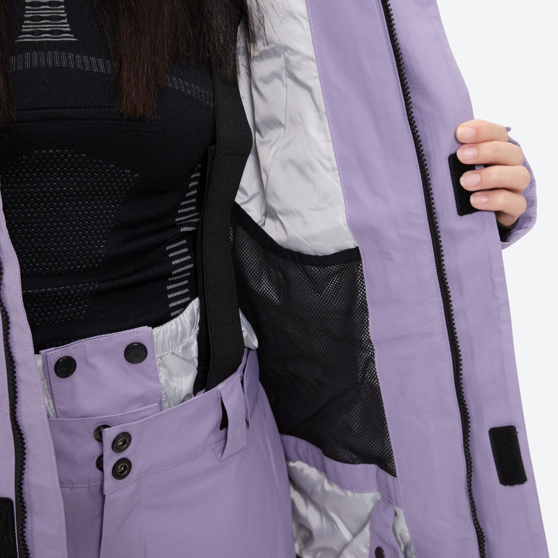 Women's breathable ski jacket with suspender pants - lavender, interior lining close-up with hand, for snowy mountain travel