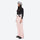 Women's waterproof 2L ski jacket and bib pants - light pink snow pants, on-model side view, for snowy mountain travel