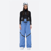 
                  
                    Women's breathable ski jacket with iridescent straps - ice blue snow pants with black top, for cold-weather winter sports
                  
                
