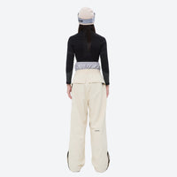 
                  
                    Waterproof snow jacket and pants set - women's cream pants with black base layer, for resort and backcountry days
                  
                