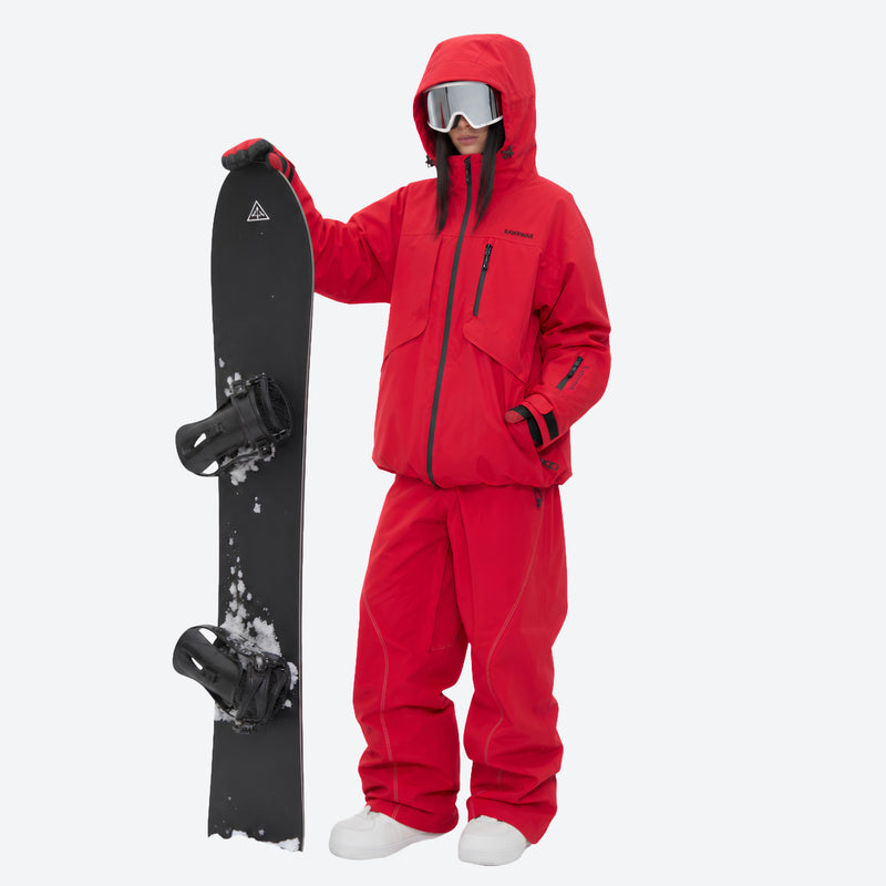 Waterproof snow jacket and pants set - red, on-model front with upright snowboard, for skiing and snowboarding