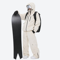 
                  
                    Waterproof snow jacket and pants set - cream, on-model front with snowboard and backpack, for cold-weather winter sports
                  
                
