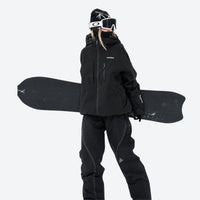
                  
                    Colorblock snowboard jacket and pants set - black, on-model front holding snowboard horizontal, for powder and piste riding
                  
                