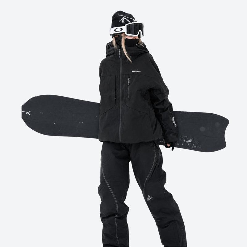 Colorblock snowboard jacket and pants set - black, on-model front holding snowboard horizontal, for powder and piste riding