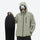 Waterproof snow jacket and pants set - sage green, on-model front with upright snowboard, for skiing and snowboarding