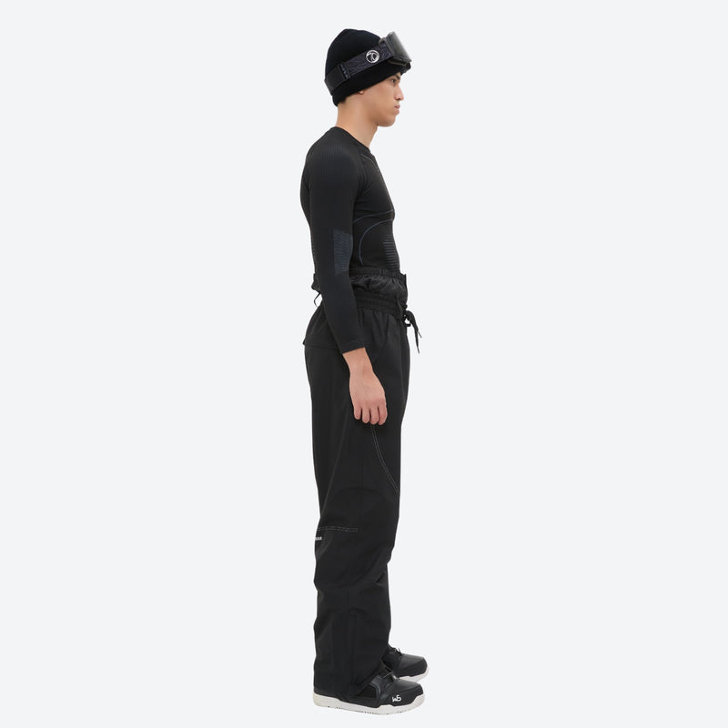 Men's colorblock snowboard jacket and pants - black pants, on-model side view, for cold-weather winter sports