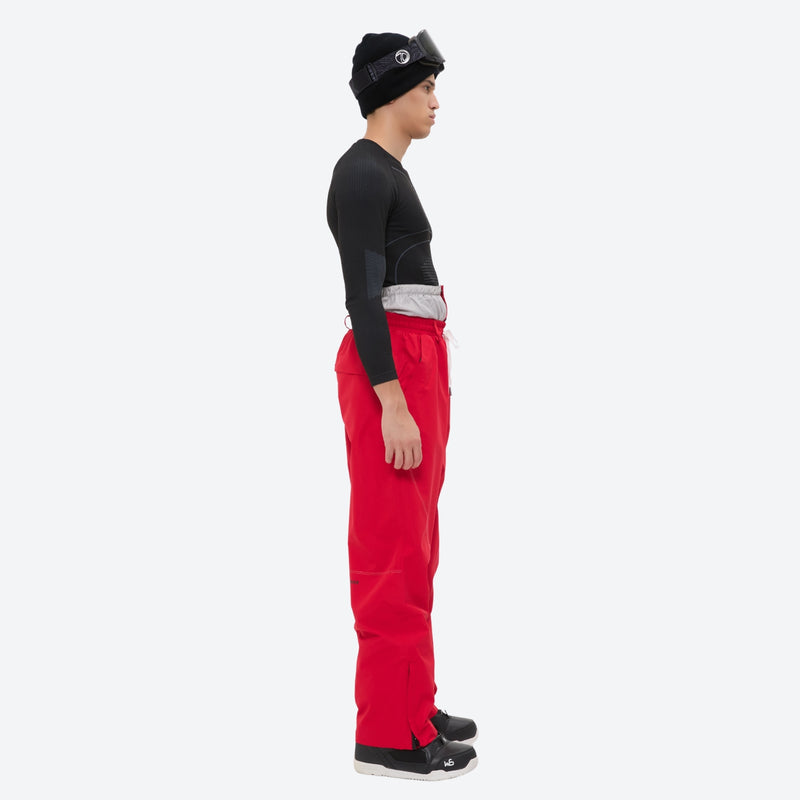 Men's breathable ski jacket and pants combo - red pants, on-model side view, for skiing and snowboarding