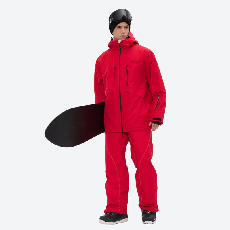 Men's colorblock snowboard jacket and pants - red, on-model front holding snowboard horizontal, for powder and piste riding