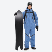 
                  
                    Men's colorblock snowboard jacket and pants - blue, on-model front with snowboard and backpack, for powder and piste riding
                  
                