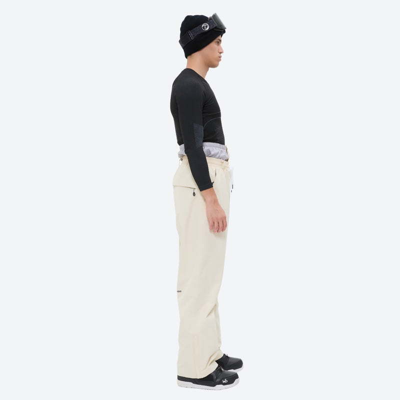 Men's waterproof 2L snow jacket and pants set - cream pants, on-model side view, for powder and piste riding