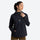 Women's waterproof hooded anorak jacket - black hooded anorak, front view with hand at chest, for resort and street wear