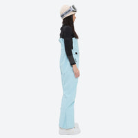 
                  
                    Unisex waterproof 3L snow bib pants - ice blue bib pants with black top, on-model side view, for skiing and snowboarding
                  
                