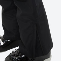 
                  
                    Unisex snowboard bib pants with snow gaiters - black, hem snow gaiter over boot close-up detail, for powder and piste riding
                  
                