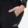 Unisex waterproof 3L snow bib pants - black, side pocket close-up with hand, for cold-weather winter sports