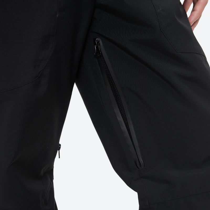 Unisex snowboard bib pants with snow gaiters - black, thigh zip vent close-up detail, for resort and backcountry days