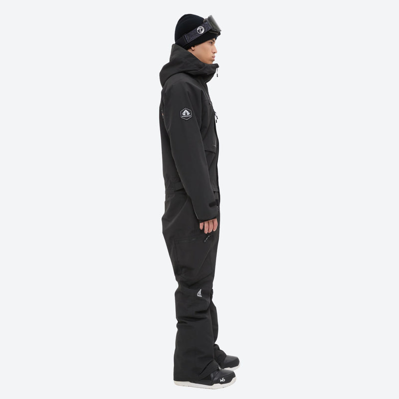 Men's one-piece snowboard suit with waist belt - black one-piece snow suit, on-model side view, for skiing and snowboarding