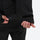 Unisex waterproof one-piece snow suit - black one-piece suit, cuff strap close-up with hand, for resort and backcountry days