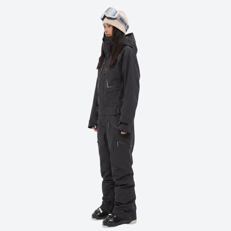 Breathable full-body ski suit with waist belt - black one-piece suit, on-model side view, for powder and piste riding