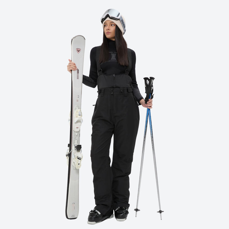 Women's 2-layer insulated ski suit - black snow pants, front with upright skis and poles, for snowy mountain travel