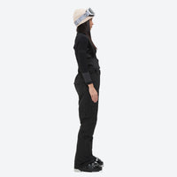 
                  
                    Women's breathable snow jacket with suspender pants - black snow pants, on-model side view, for resort and cross-country days
                  
                